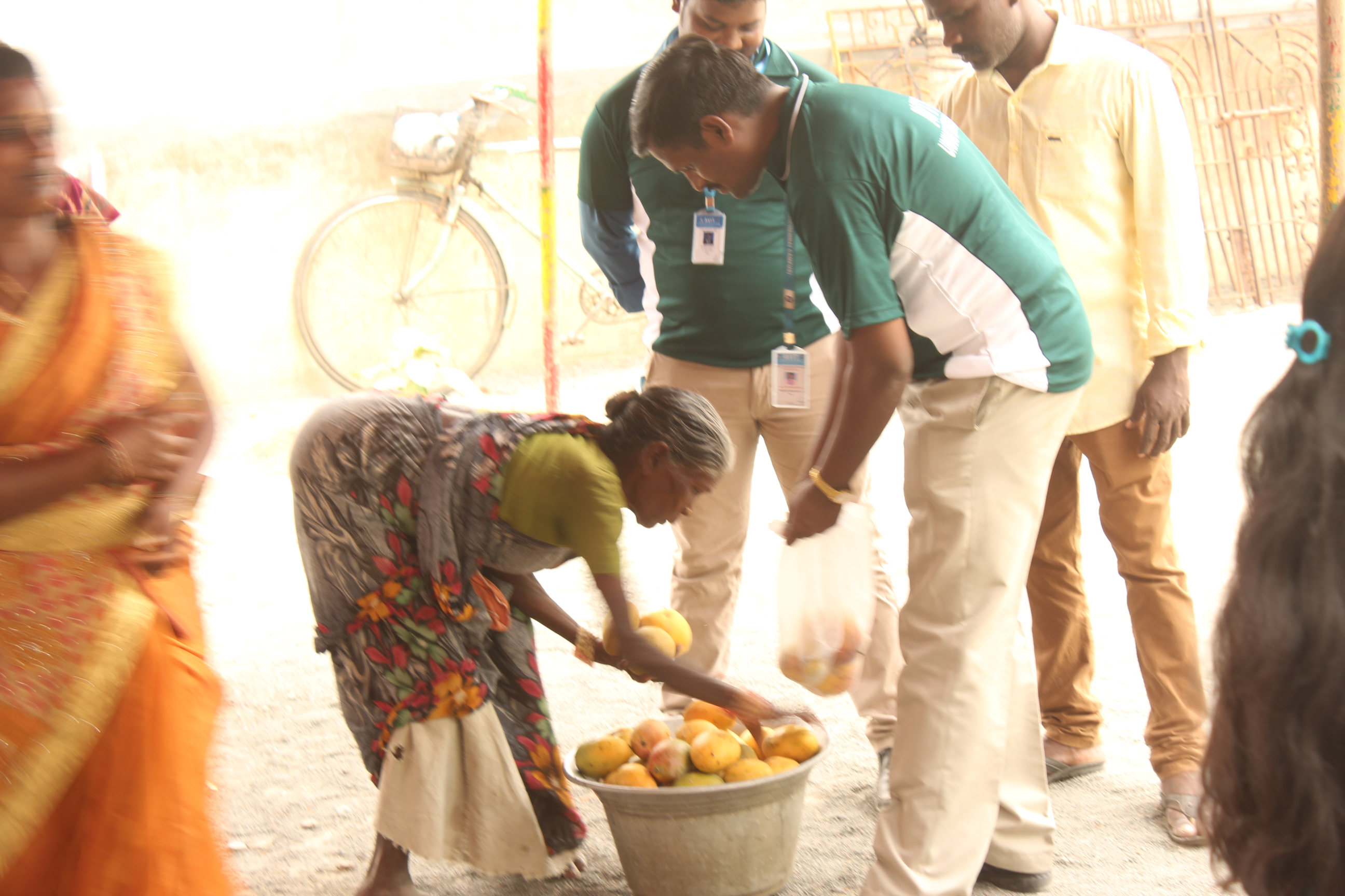 Naduvakkarai Villagers giving mangoes to UBA members of AVIT
